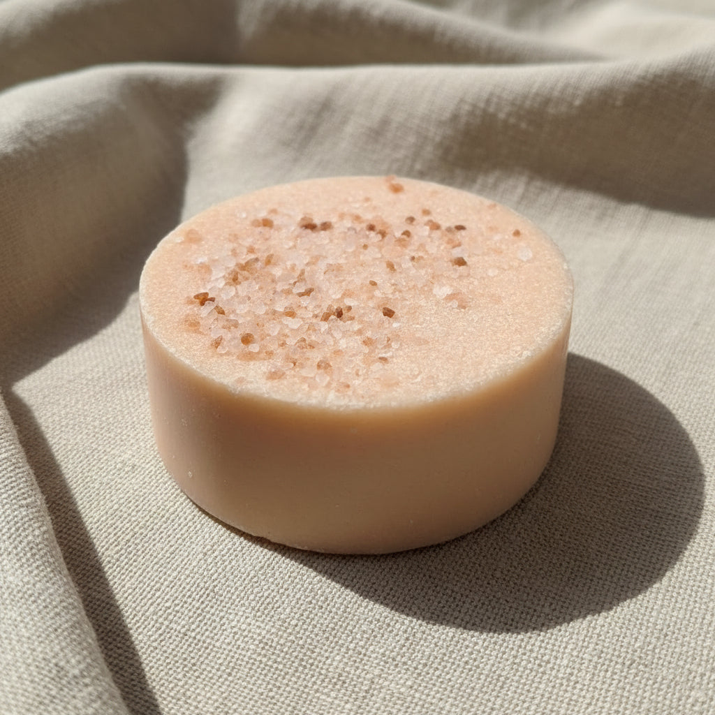 Round pink soap on linen
