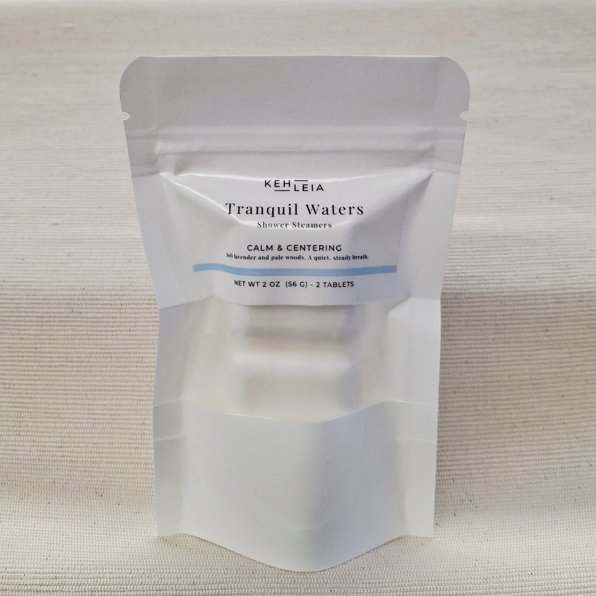 KEHLEIA Tranquil Waters shower steamers packaging on a textured beige background