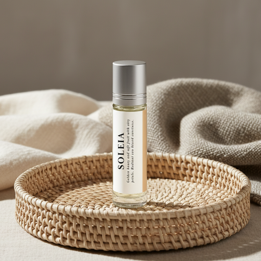 Roll-on bottle of 'Soleia' on a woven tray with beige fabric background